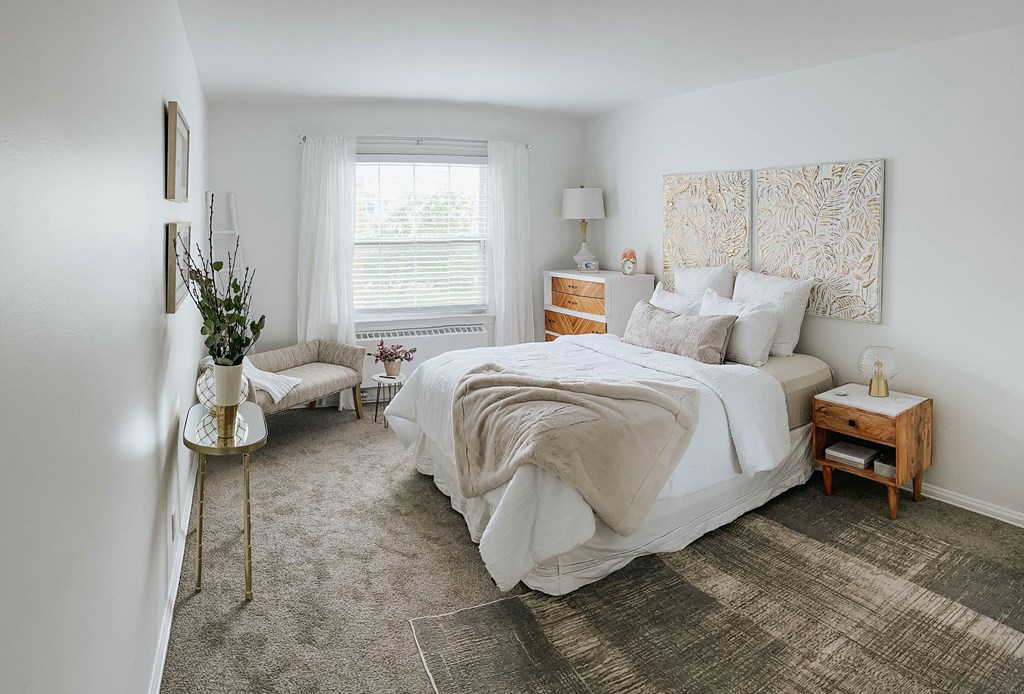 a bedroom with a bed and a window