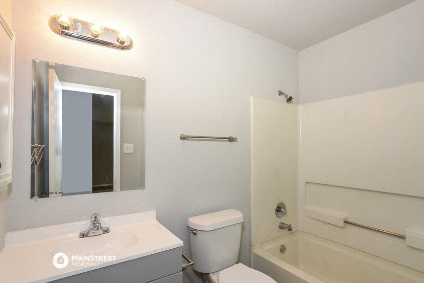 a bathroom with a sink and a toilet and a bath tub