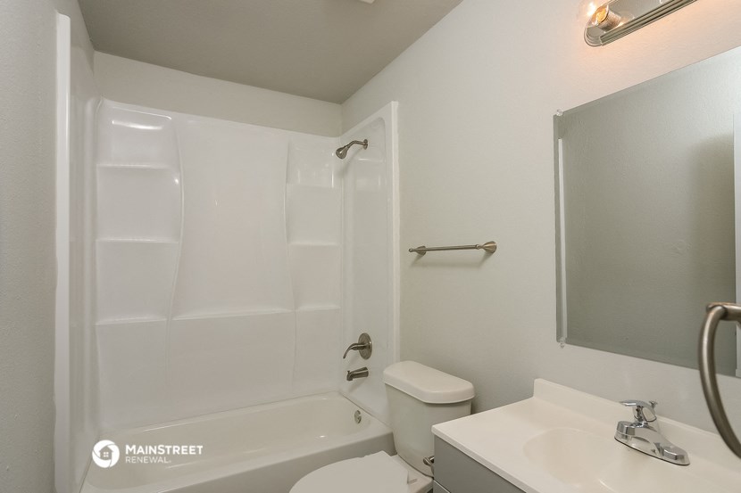 a bathroom with a shower and a sink and a toilet