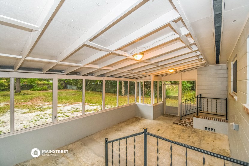 a view of the upstairs of a house with large windows and a balcony