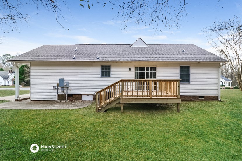 a white house with a porch and a deck