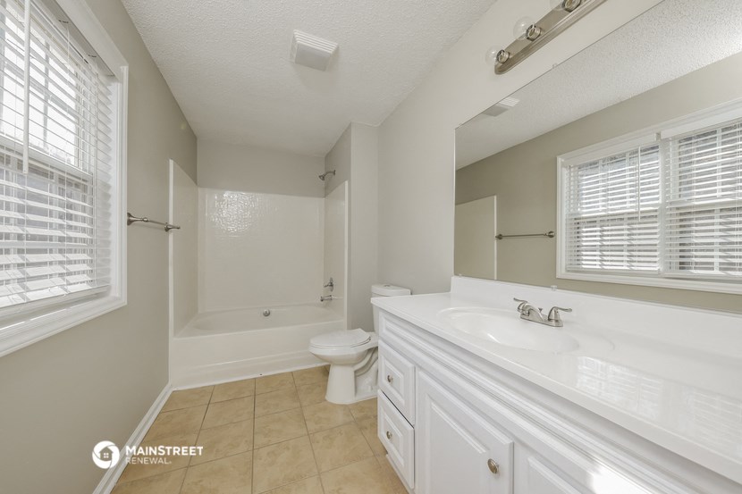 a bathroom with a sink and a toilet and a bath tub