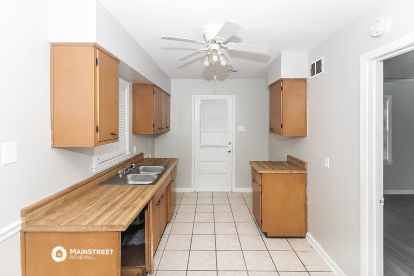 a kitchen with wooden cabinets and a counter top