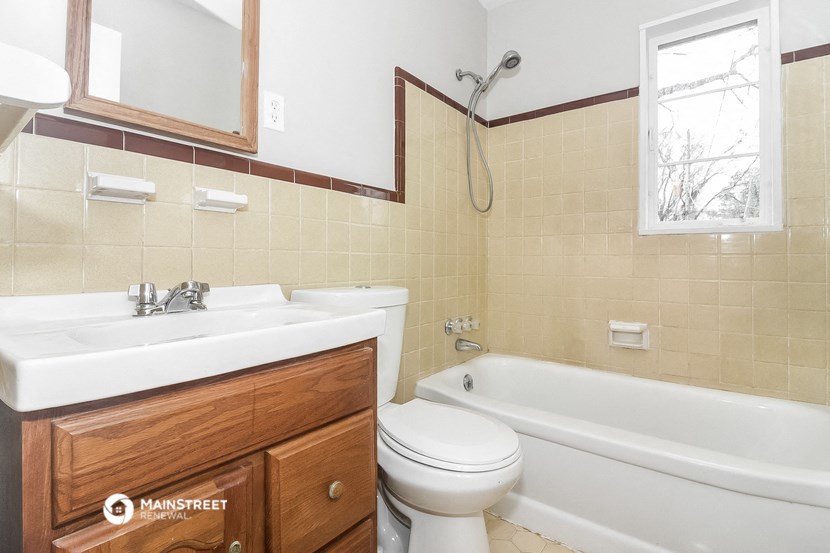 a bathroom with a sink toilet and a bath tub