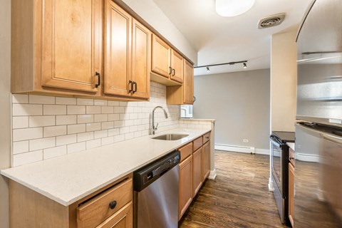 a kitchen with wooden cabinets and a sink