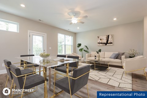a living room and dining room with a glass table and chairs