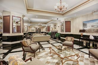 a lobby of a hotel with couches and chairs