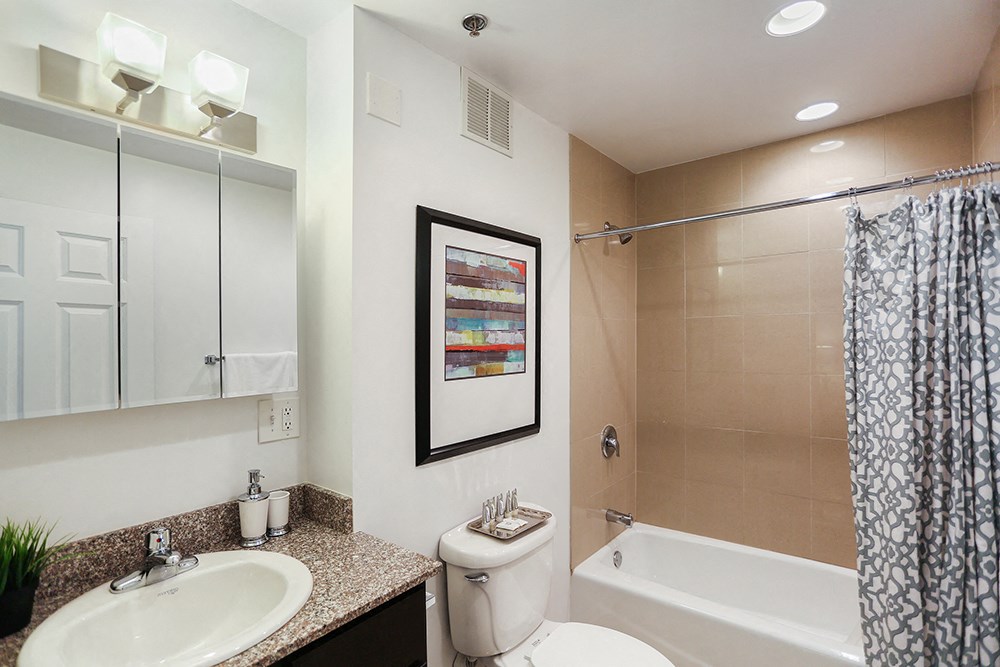 a bathroom with a shower toilet and sink and a mirror