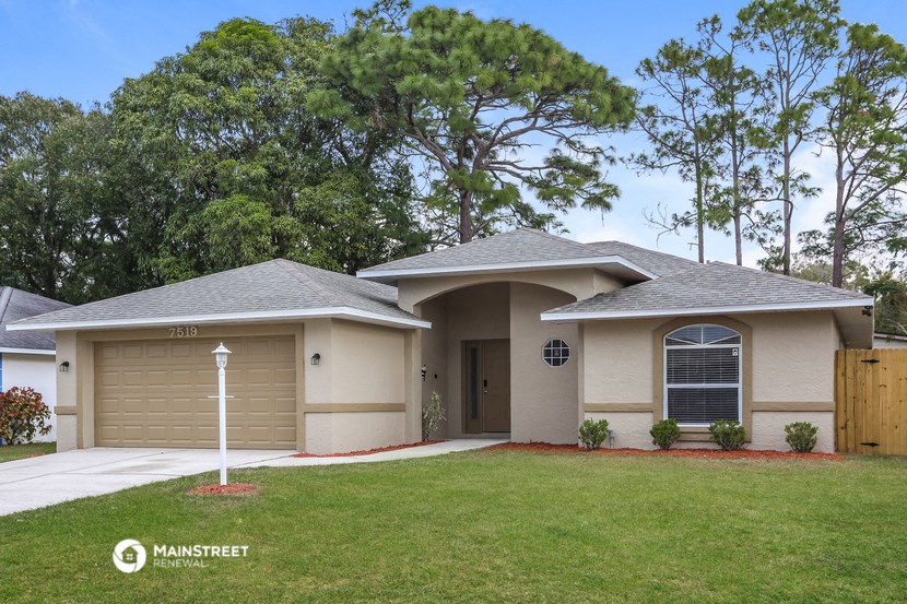 a house with a lawn and a garage door