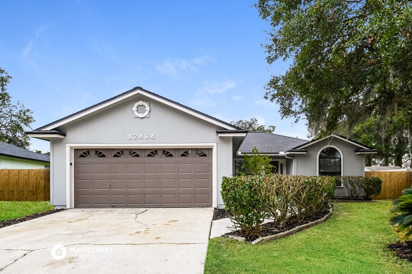 a house with a garage door and a lawn