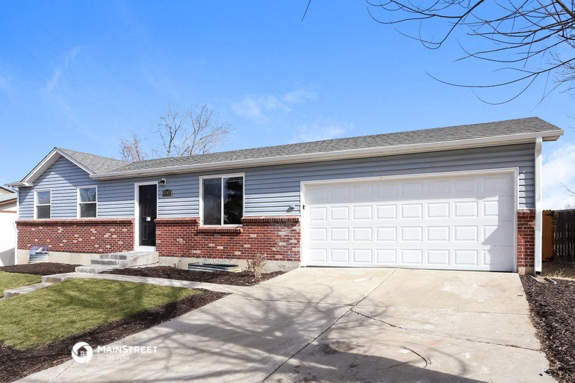 a blue house with a white garage door