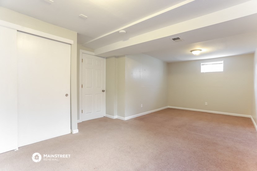 a room with a carpet and a door to a closet