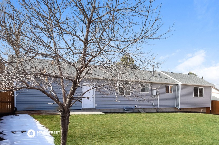 a blue house with a tree in front of it