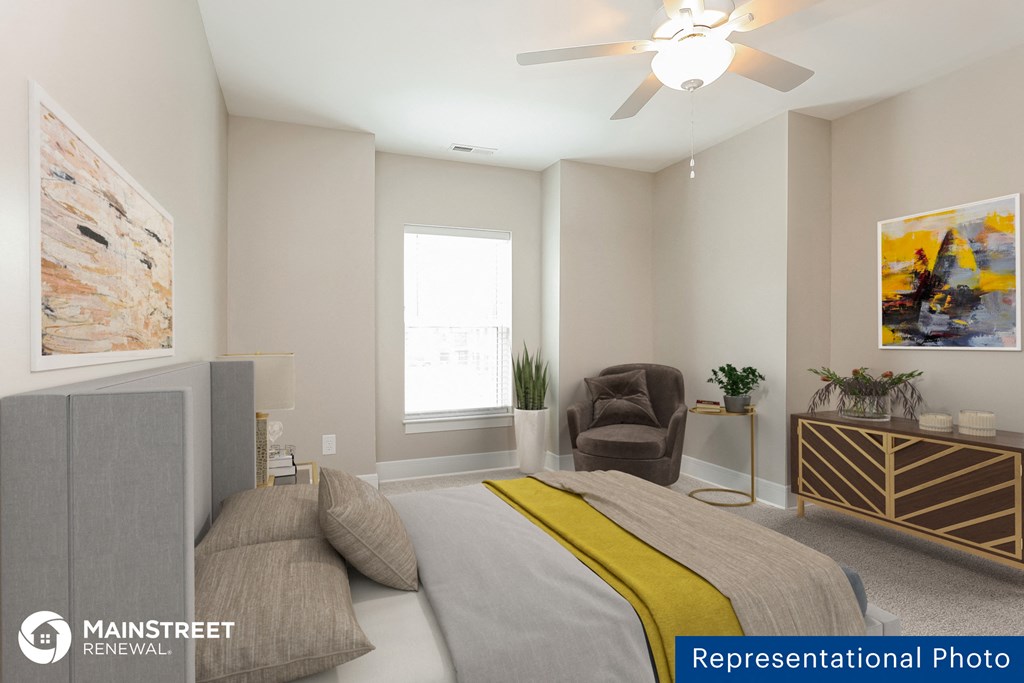 a bedroom with a bed and a ceiling fan