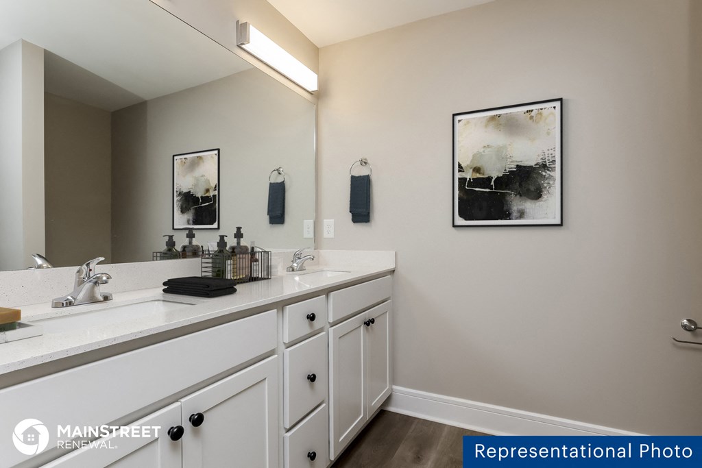 a bathroom with two sinks and a mirror