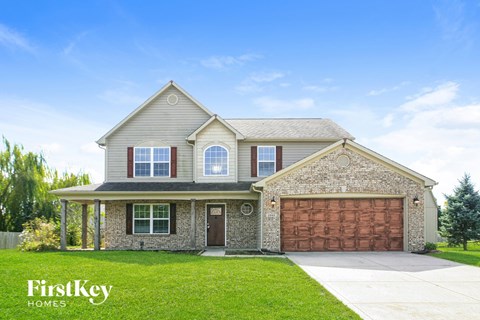 A house with a garage and a driveway is for sale.