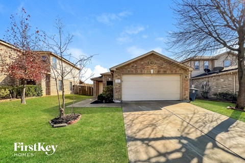 a house with a garage door and a lawn
