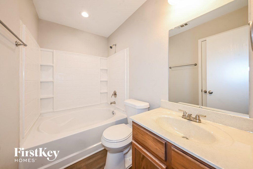 a bathroom with a sink toilet and a bath tub