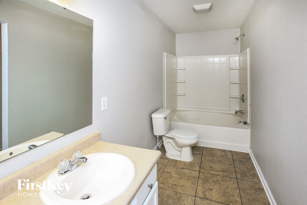 a bathroom with a sink and a toilet and a bath tub