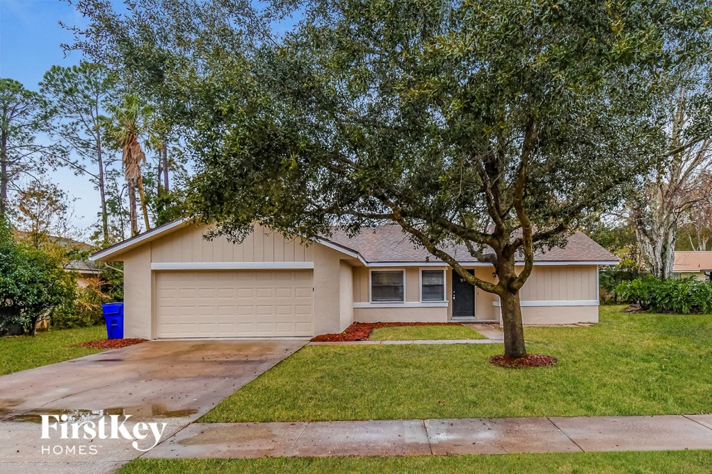 A house with a tree in front of it.
