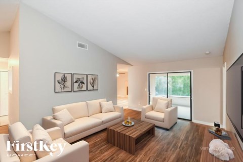 A living room with a white couch and a coffee table.