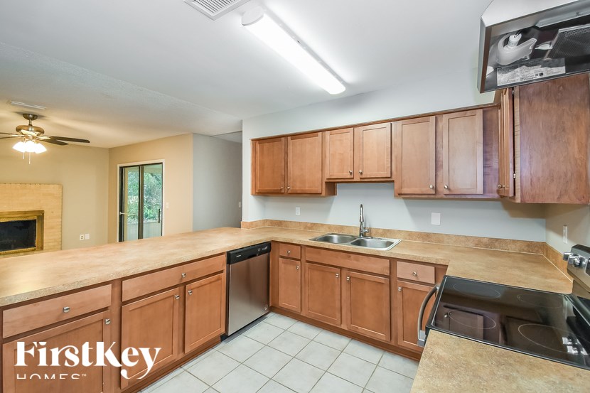 A kitchen with wooden cabinets and a sink.