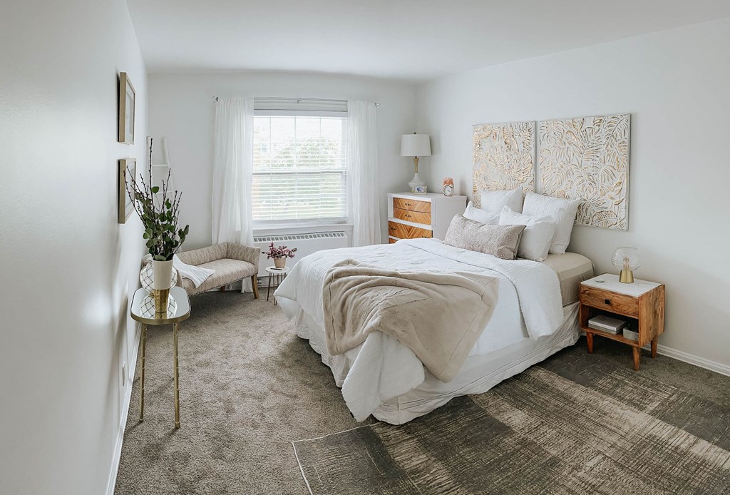 a bedroom with a bed and a window