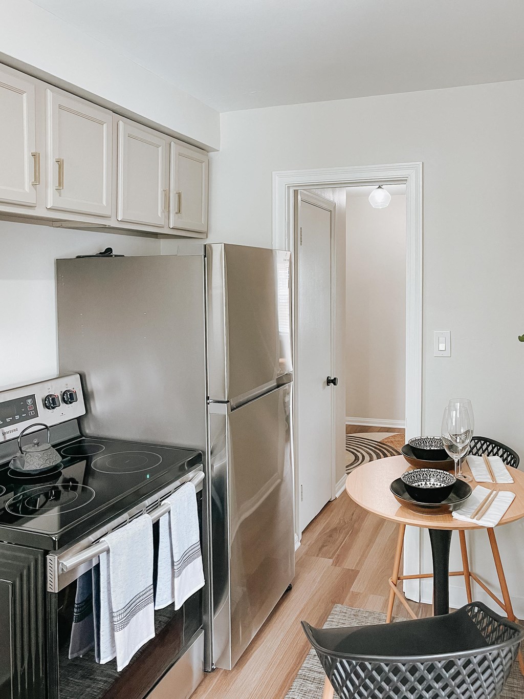 a kitchen with stainless steel appliances and a small dining table