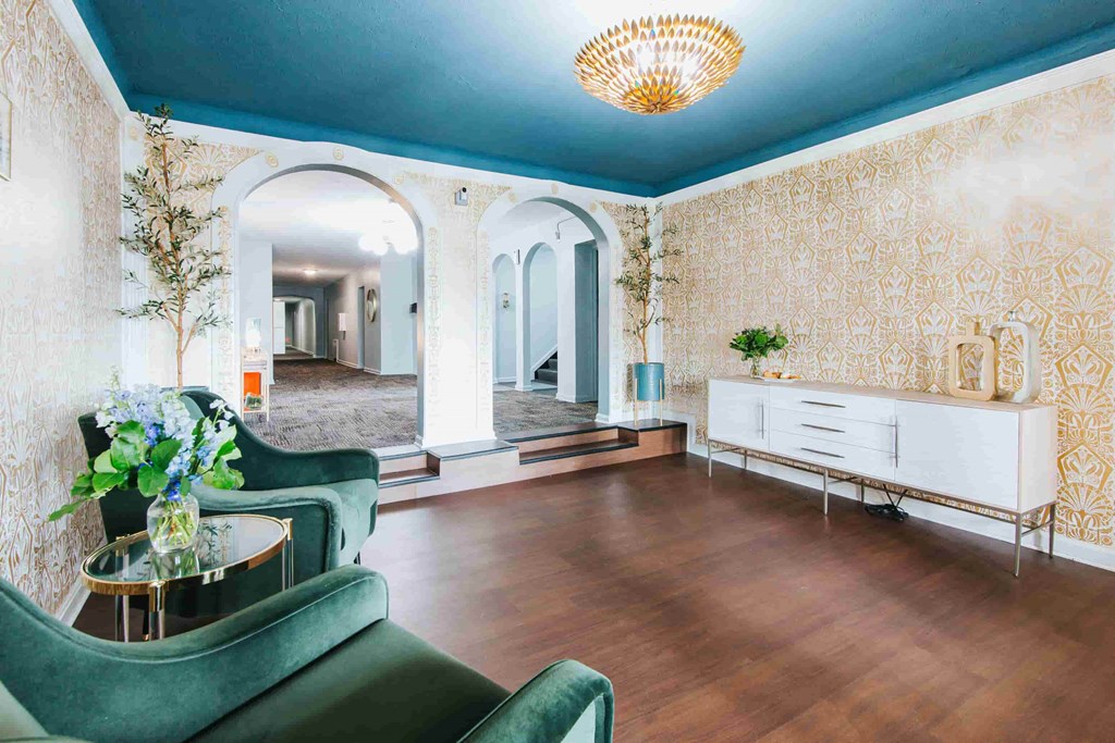 a living room with green furniture and a blue ceiling