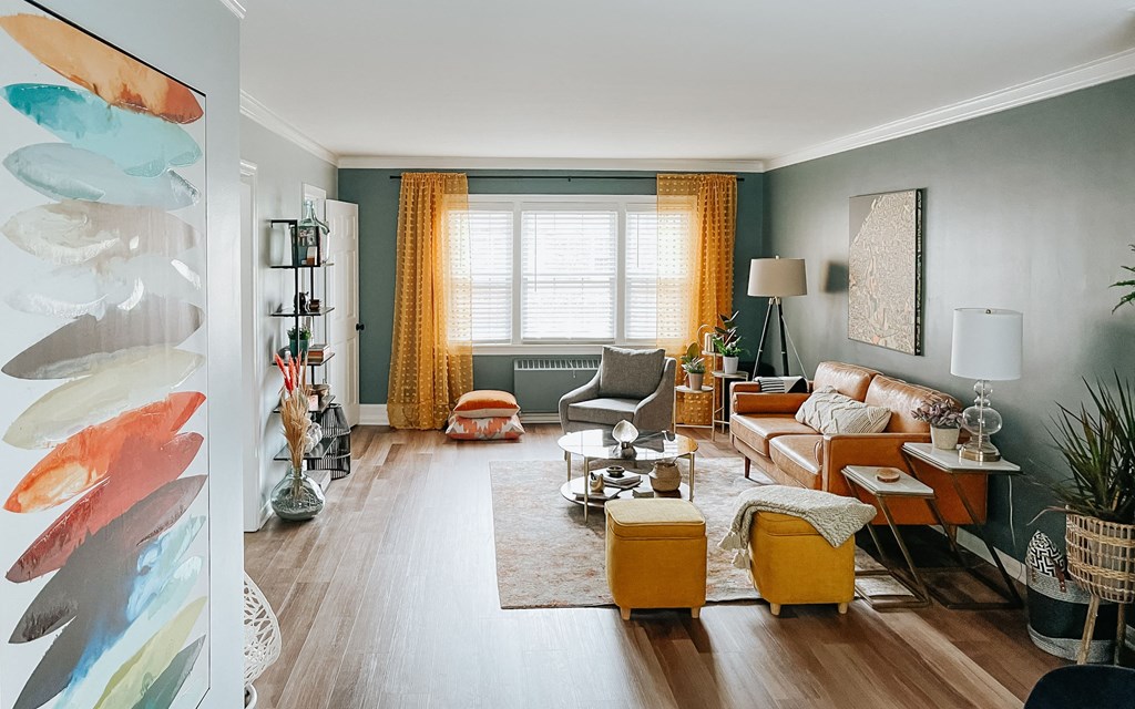 a living room filled with furniture and a large window