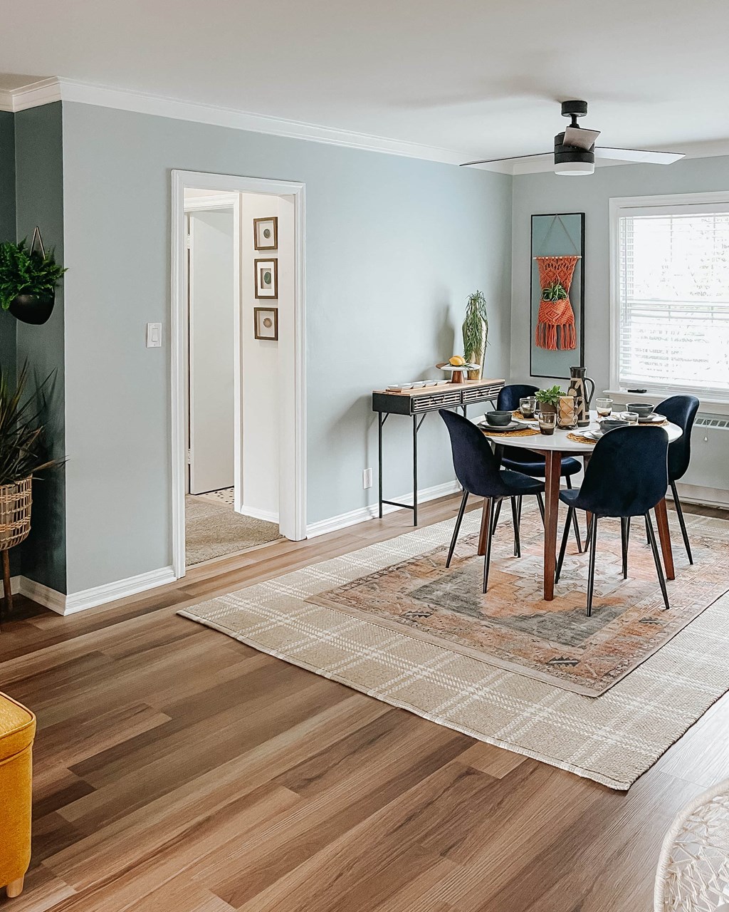 a living room and dining room with a table and chairs