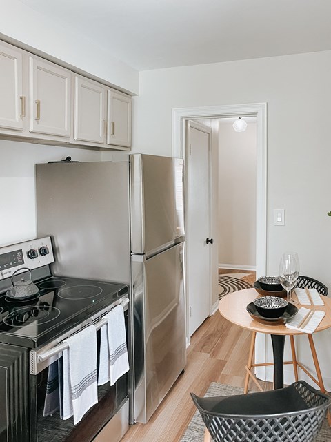 a kitchen with stainless steel appliances and a small table