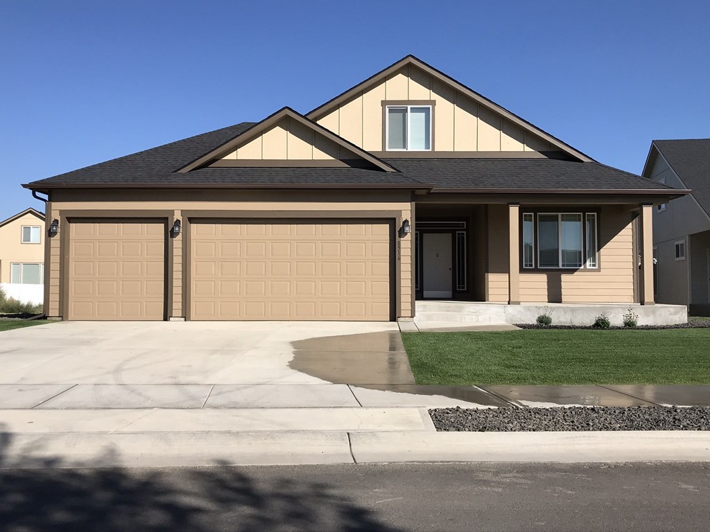 a house with a garage door in front of it