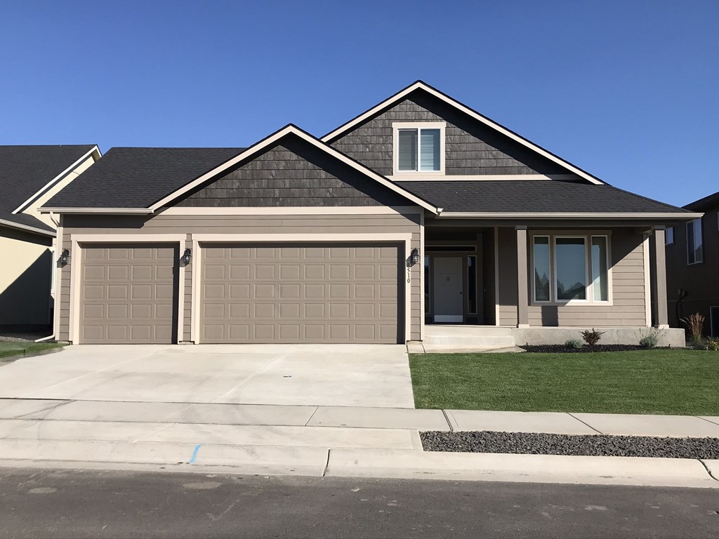 a house with a garage door in front of it