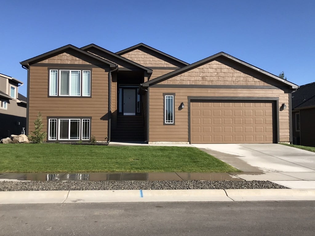 a brown house with a brown garage door