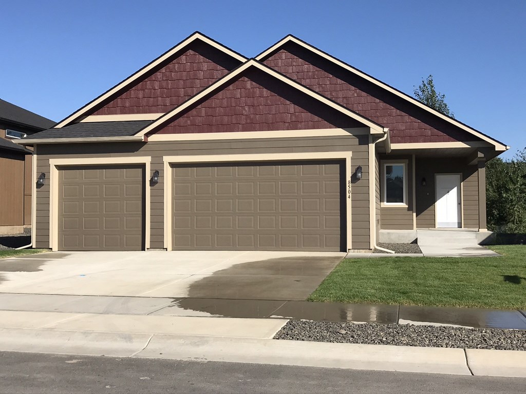 a house with two garage doors in front of it
