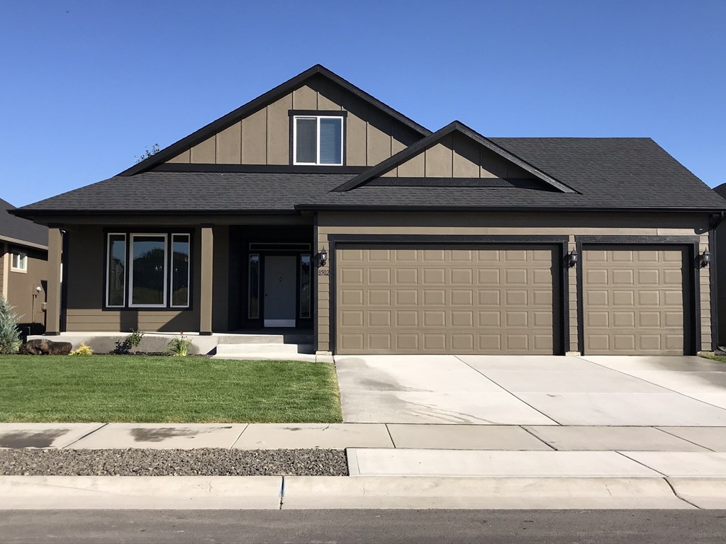 a house with a driveway and a garage door