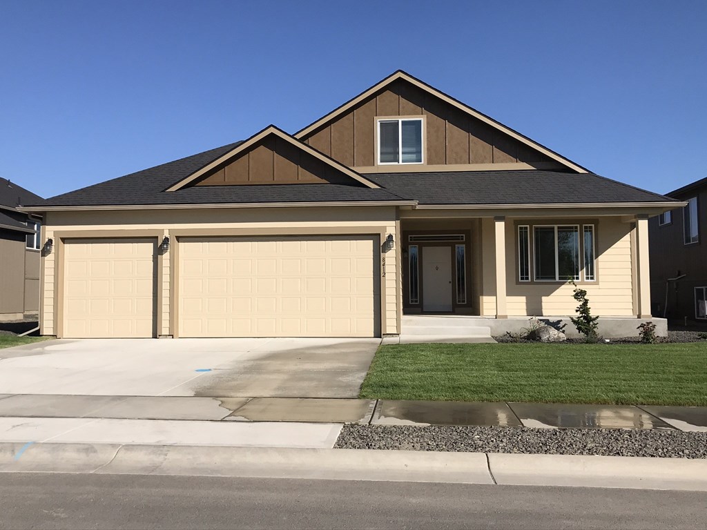 a house with a garage door in front of it