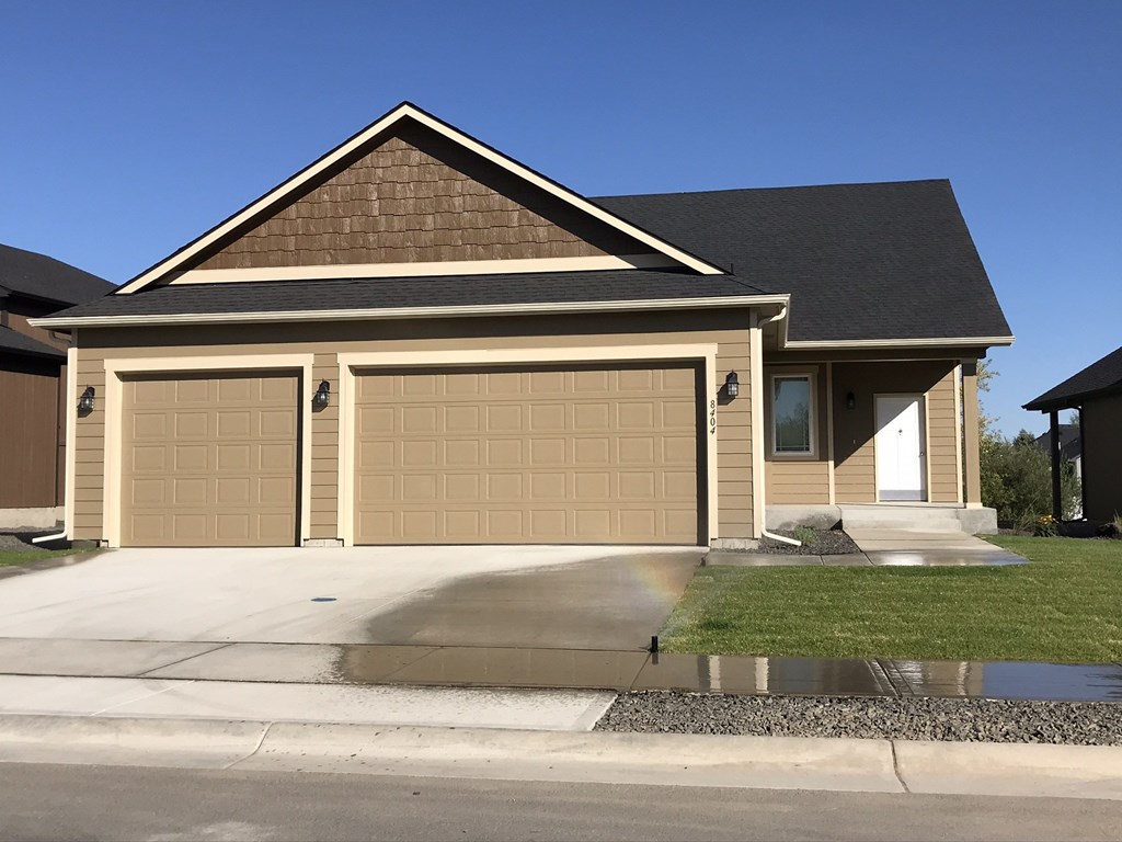 a house with a garage door in front of it