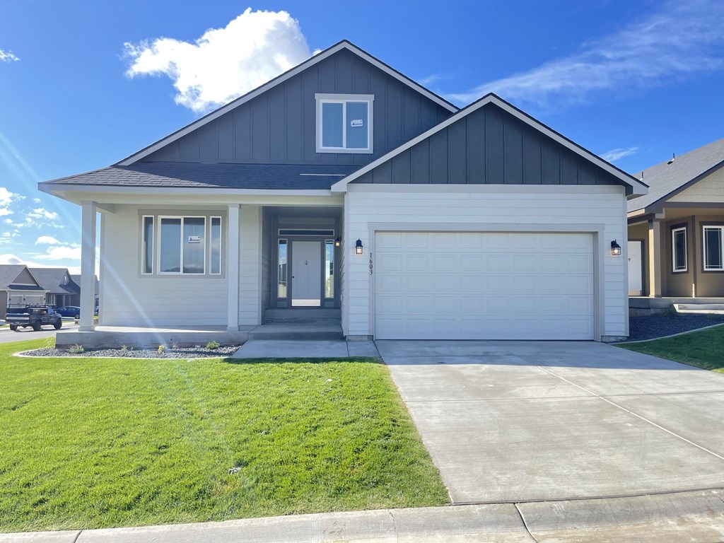 a white house with a driveway and a garage door