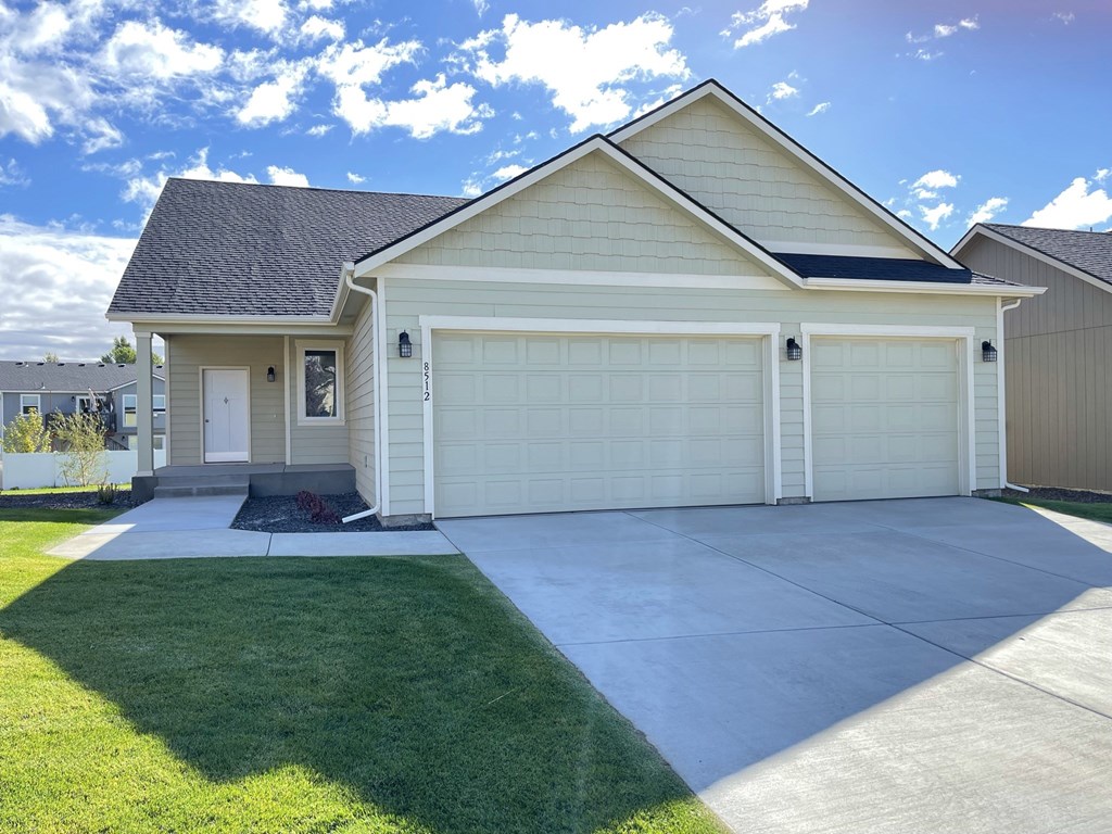 a white house with a driveway and a garage door