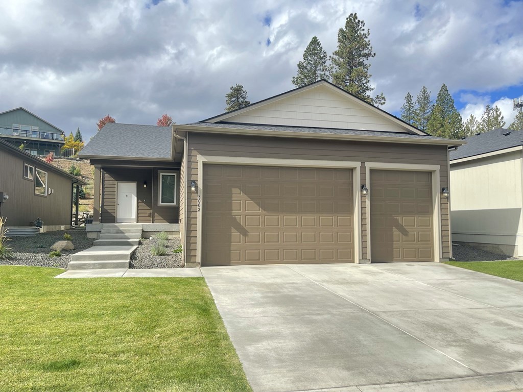 a house with a garage door and a driveway