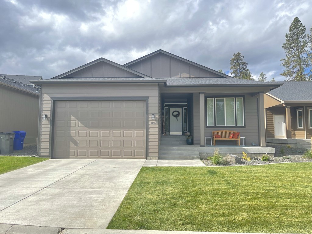 a home with a garage door and a lawn