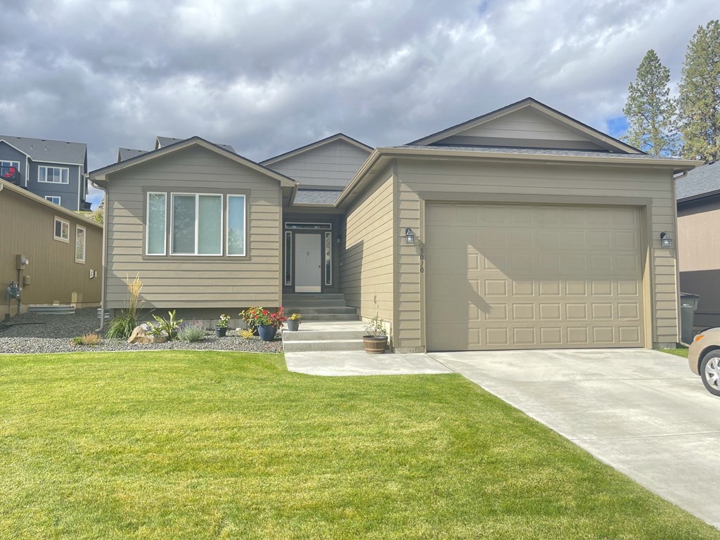 a home with a driveway and a garage door