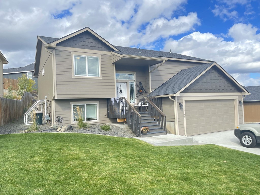 a house with a yard and a car parked in front of it