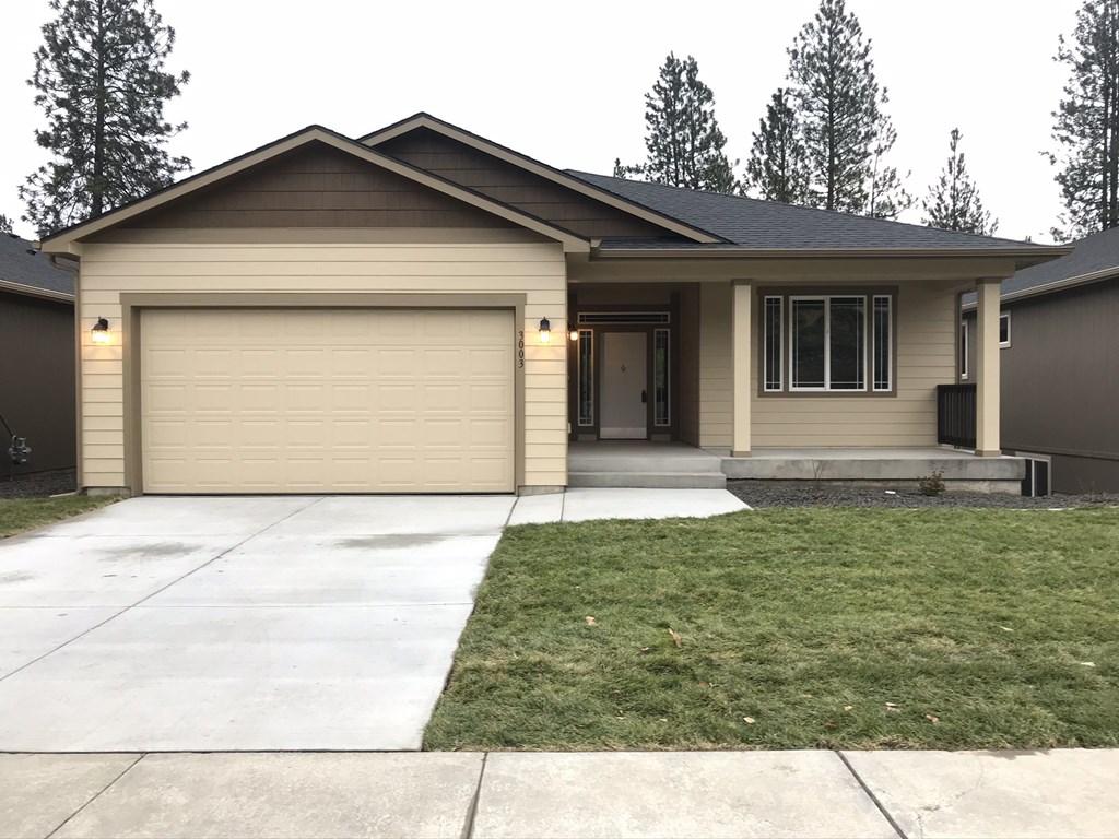 a home with a driveway and a garage door