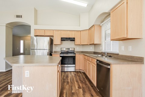 A kitchen with wooden cabinets and stainless steel appliances.