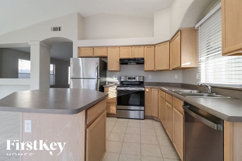 A kitchen with wooden cabinets and stainless steel appliances.