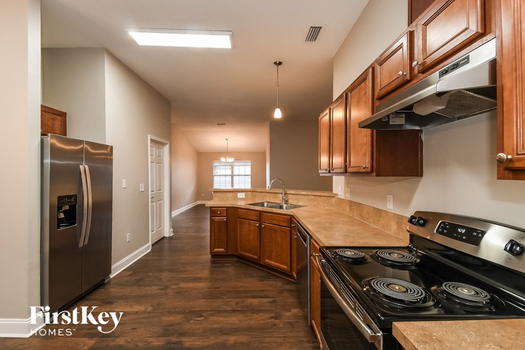 a kitchen with wooden cabinets and stainless steel appliances