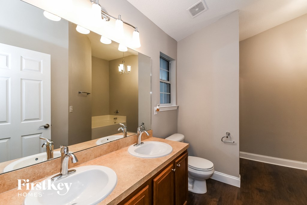 a bathroom with a sink and a toilet and a mirror